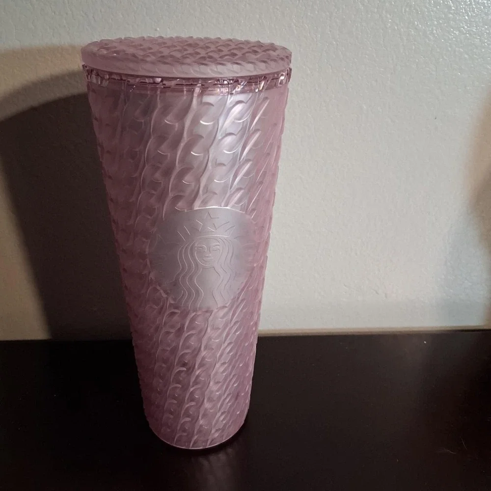 Pink Starbucks tumbler with textured wavy pattern